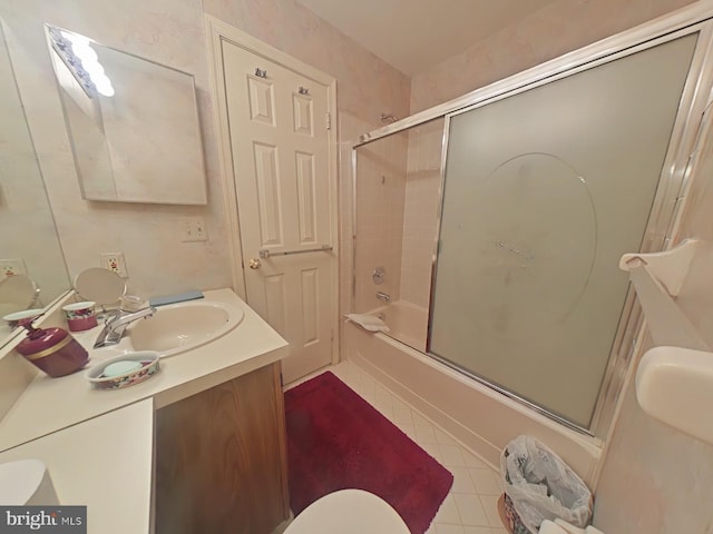 full bathroom with tile patterned floors, toilet, combined bath / shower with glass door, and vanity