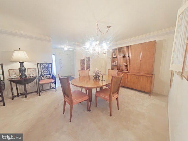 dining area featuring ornamental molding and a chandelier