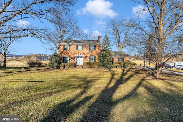 colonial house featuring a front yard