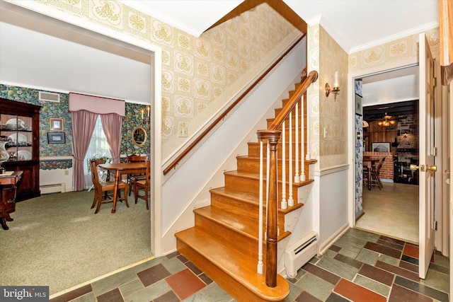 staircase featuring crown molding, carpet flooring, and a baseboard heating unit