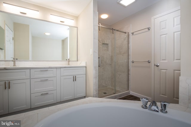 bathroom with plus walk in shower and vanity