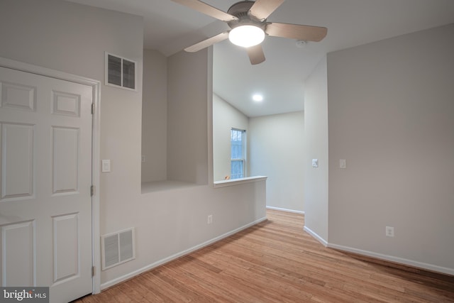 unfurnished room featuring light hardwood / wood-style flooring, ceiling fan, and vaulted ceiling