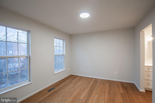 spare room featuring light hardwood / wood-style flooring