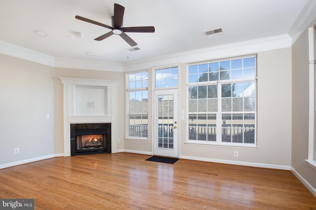 unfurnished living room with crown molding, ceiling fan, and light hardwood / wood-style floors