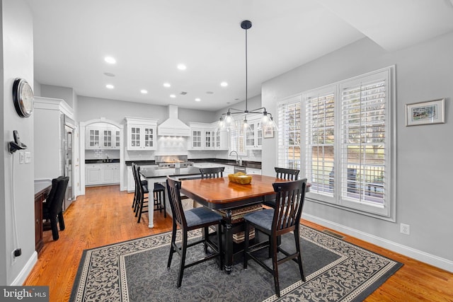 dining area featuring sink and light wood-type flooring