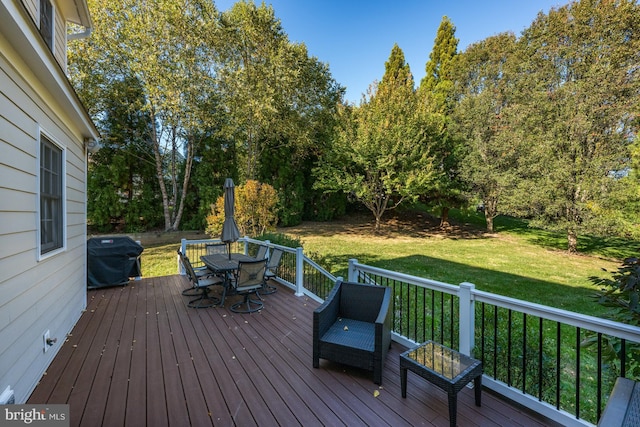 wooden deck with a grill and a yard