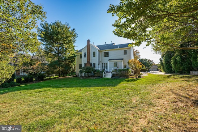 rear view of property with a lawn