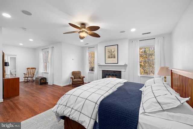 bedroom with dark hardwood / wood-style flooring and ceiling fan