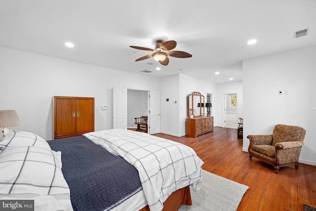 bedroom with hardwood / wood-style floors and ceiling fan