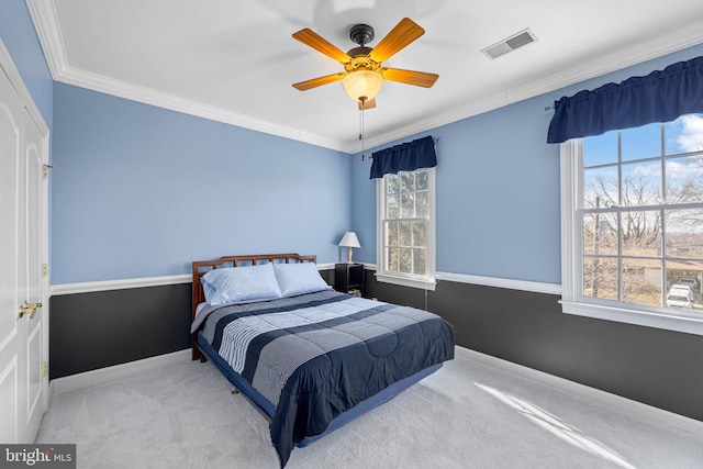 carpeted bedroom with crown molding and ceiling fan