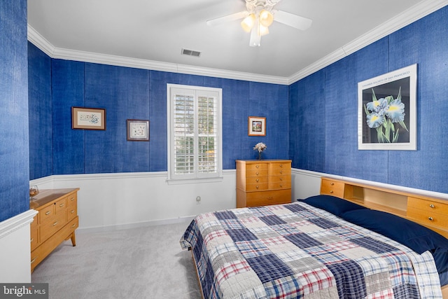 carpeted bedroom featuring ceiling fan and ornamental molding