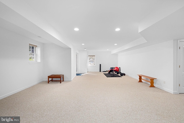 interior space with a healthy amount of sunlight and light carpet