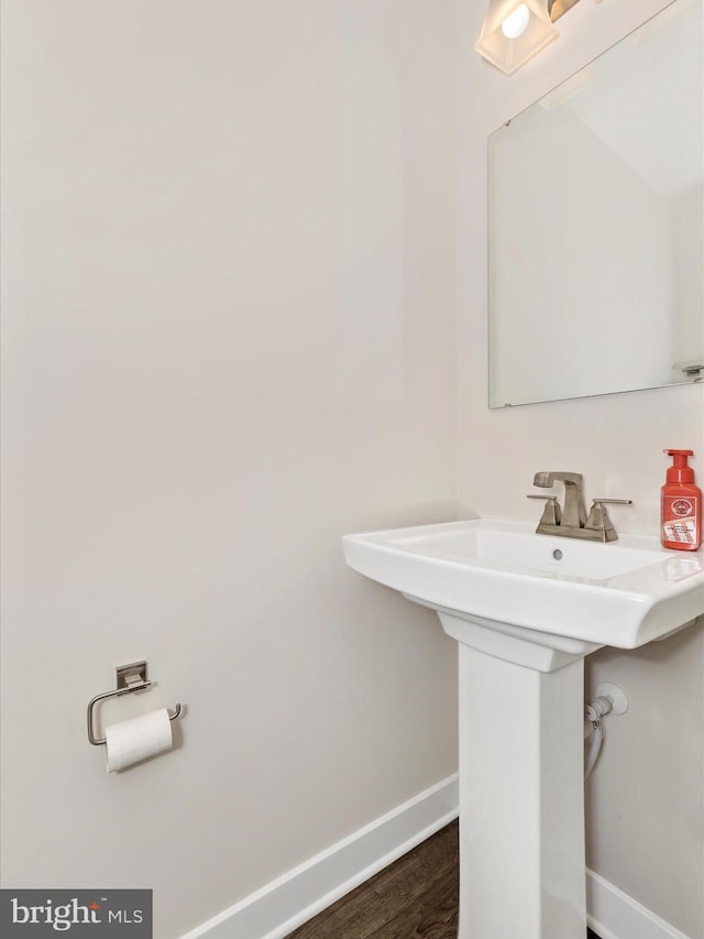 bathroom with hardwood / wood-style flooring