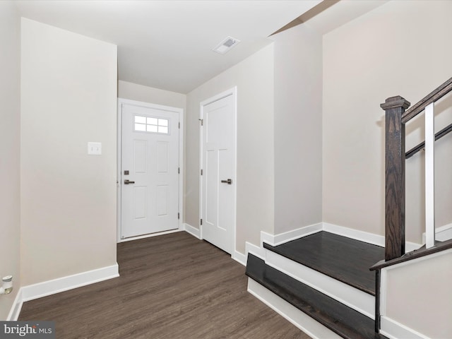 entryway with dark hardwood / wood-style flooring