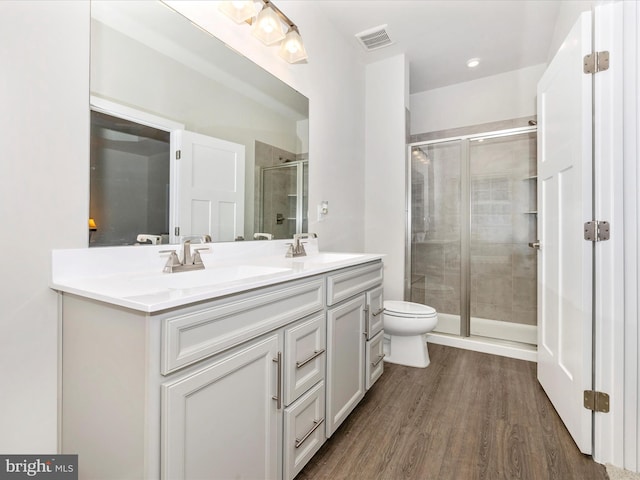 bathroom featuring hardwood / wood-style flooring, vanity, and an enclosed shower