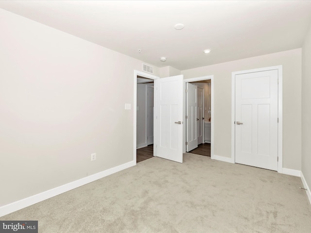 unfurnished bedroom with light colored carpet