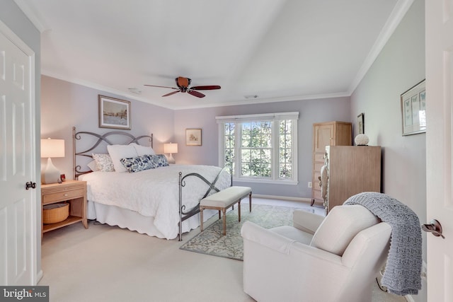 carpeted bedroom featuring ornamental molding and ceiling fan