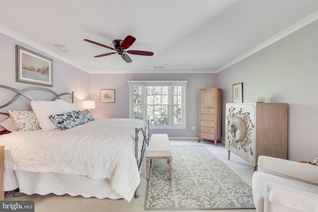 carpeted bedroom featuring crown molding and ceiling fan