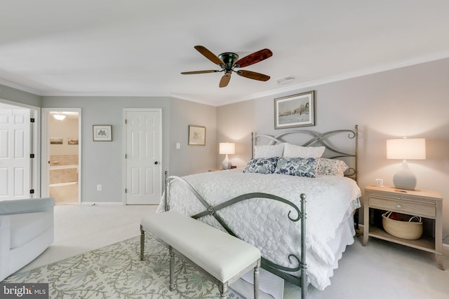 bedroom featuring crown molding, light carpet, ceiling fan, and ensuite bathroom