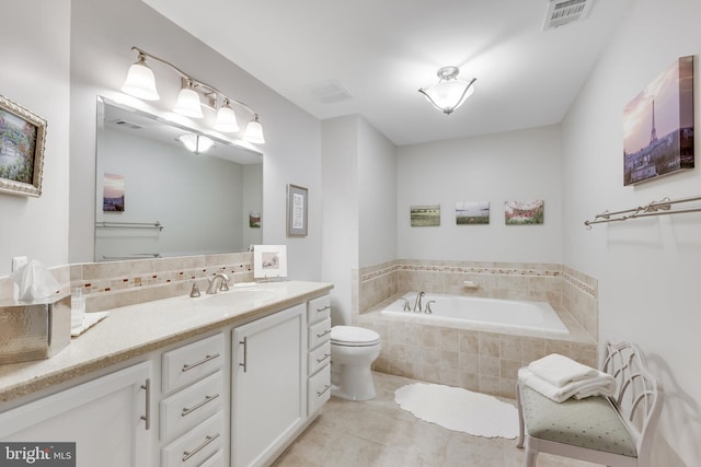 bathroom featuring a relaxing tiled tub, tile patterned floors, vanity, and toilet