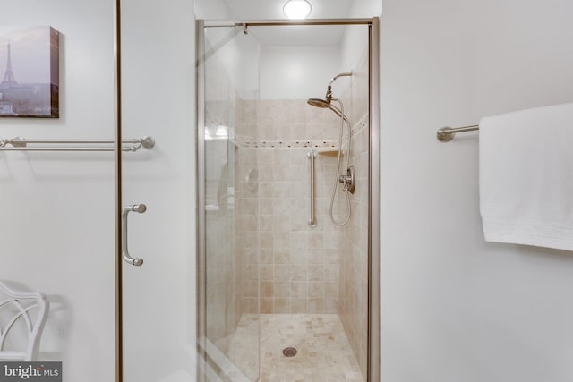 bathroom with a shower with shower door