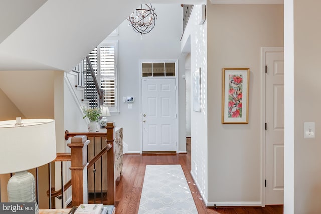 entryway featuring hardwood / wood-style floors and a notable chandelier