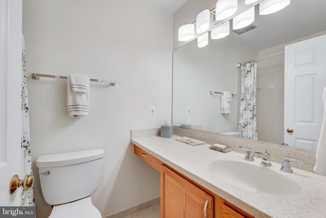 bathroom featuring vanity, curtained shower, and toilet