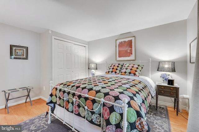 bedroom with hardwood / wood-style flooring and a closet