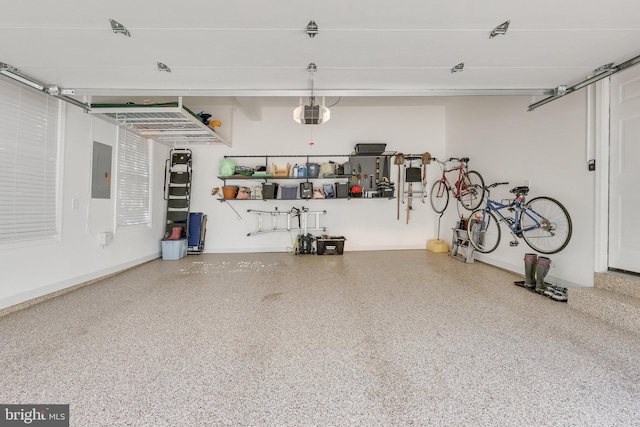 garage with a garage door opener and electric panel