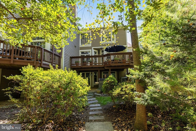 rear view of property with a wooden deck