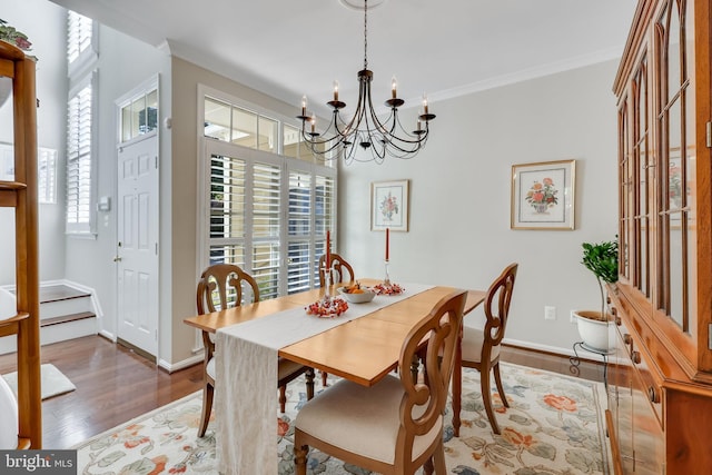 dining room featuring an inviting chandelier, crown molding, and dark hardwood / wood-style floors