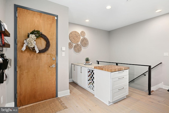 kitchen featuring white cabinetry and light hardwood / wood-style flooring