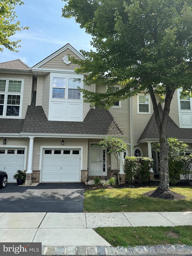 view of front of property with a garage and a front yard