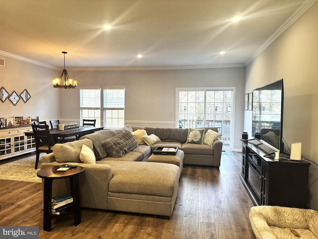 living room featuring dark wood-type flooring, a wealth of natural light, and a chandelier