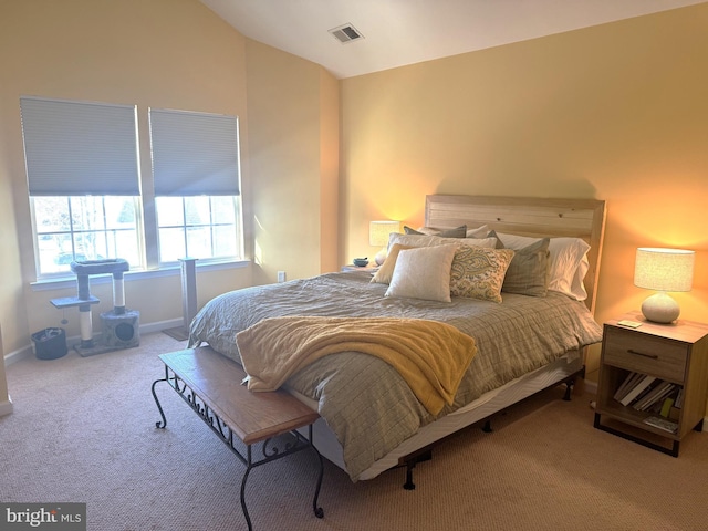 bedroom with vaulted ceiling and carpet