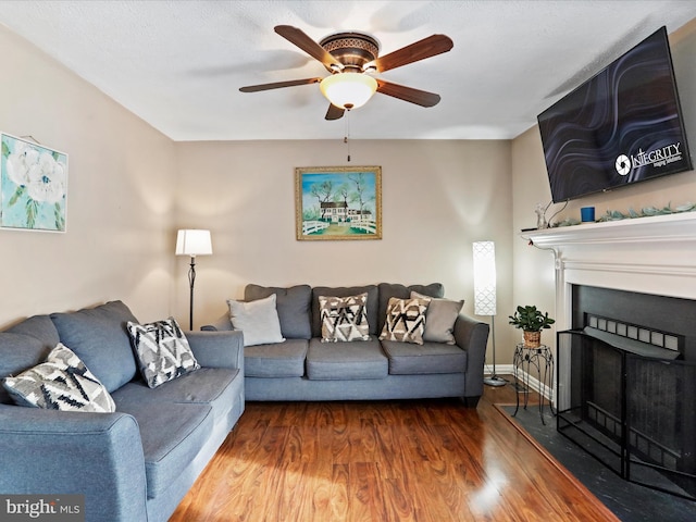 living room with ceiling fan and wood-type flooring