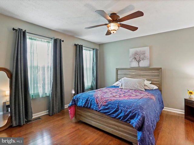 bedroom featuring wood-type flooring and ceiling fan