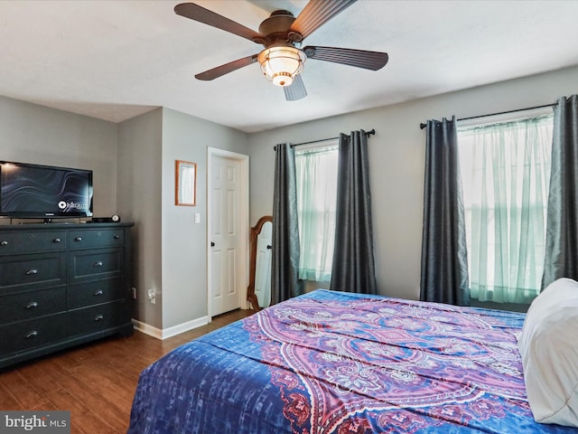 bedroom with dark wood-type flooring and ceiling fan