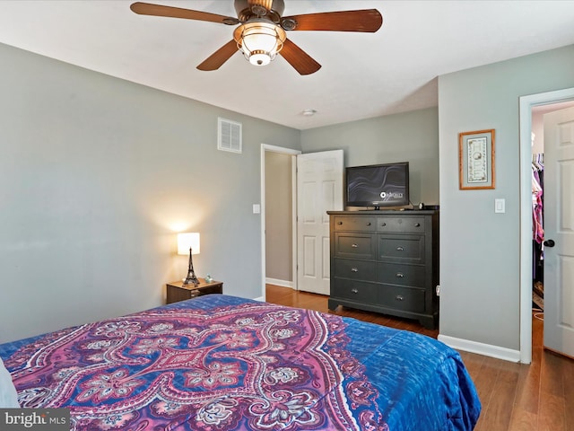 bedroom with ceiling fan and dark hardwood / wood-style flooring