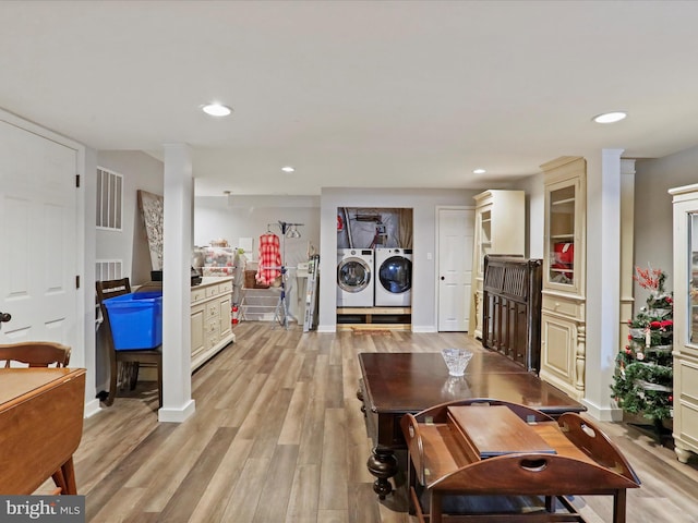 living room featuring light hardwood / wood-style floors and washer and dryer