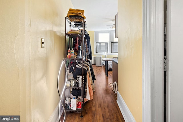 hall featuring wood-type flooring and radiator heating unit