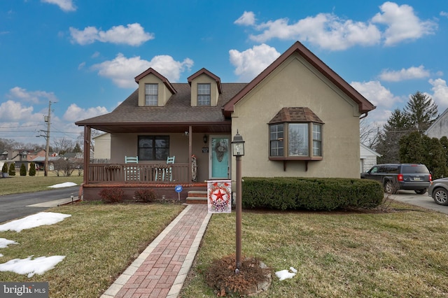 view of front of property with a porch and a front yard