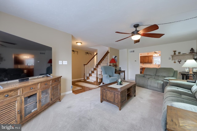 carpeted living room with ceiling fan