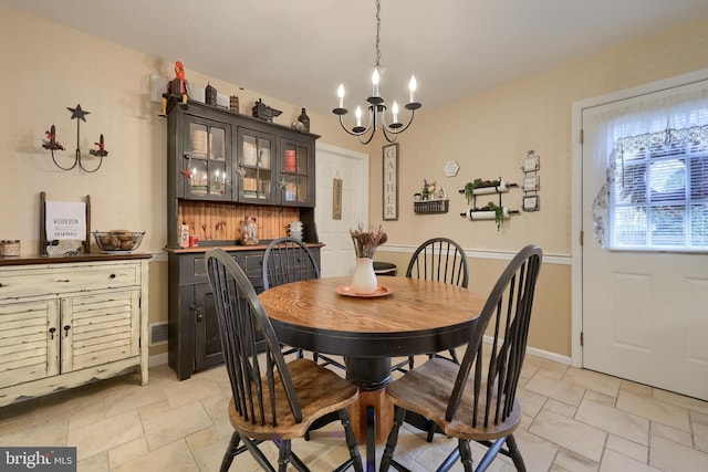 dining space with a notable chandelier