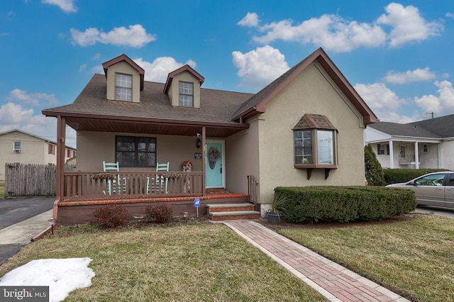 view of front of property with a porch and a front lawn