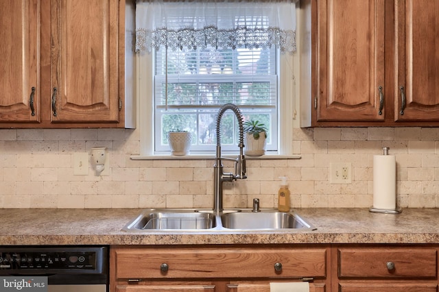 kitchen featuring sink, decorative backsplash, and dishwasher