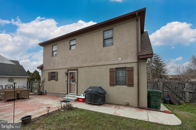 rear view of property featuring a patio area