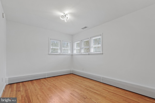 empty room with light hardwood / wood-style flooring