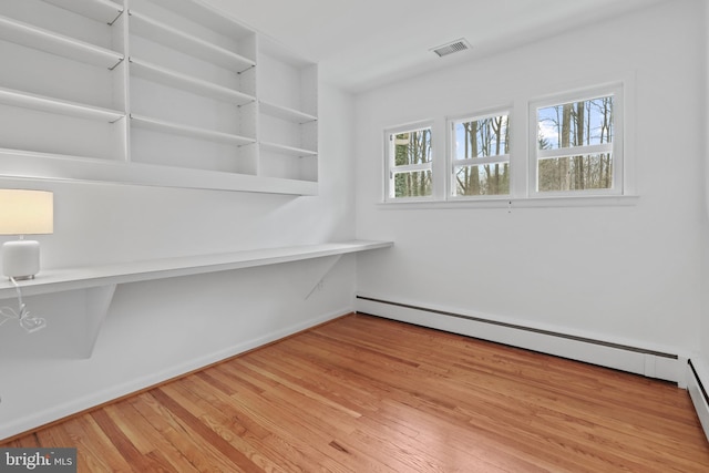 interior space with light hardwood / wood-style flooring and a baseboard radiator