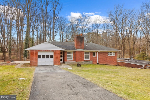 ranch-style home with a garage and a front lawn